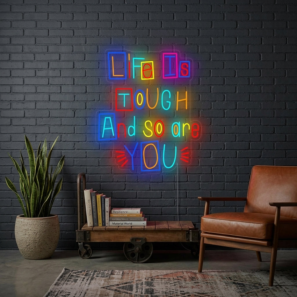 Motivational 'Life is Tough and So Are You' neon sign glowing on a stylish wall in a living room setting.