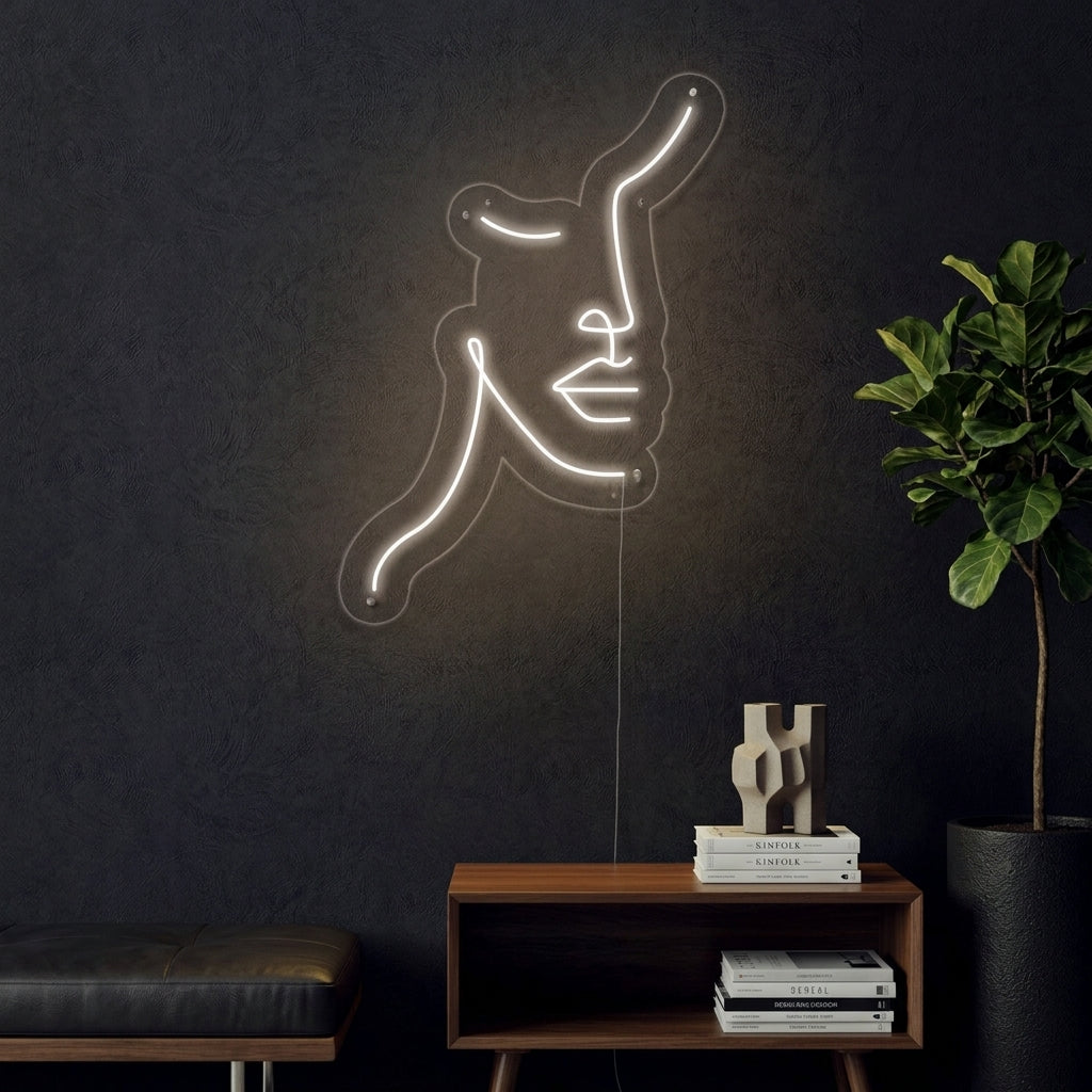 A stunning visual of the Femanine Face Line neon sign glowing warmly on a textured wall in a stylishly decorated room, creating an inviting and artistic ambiance.