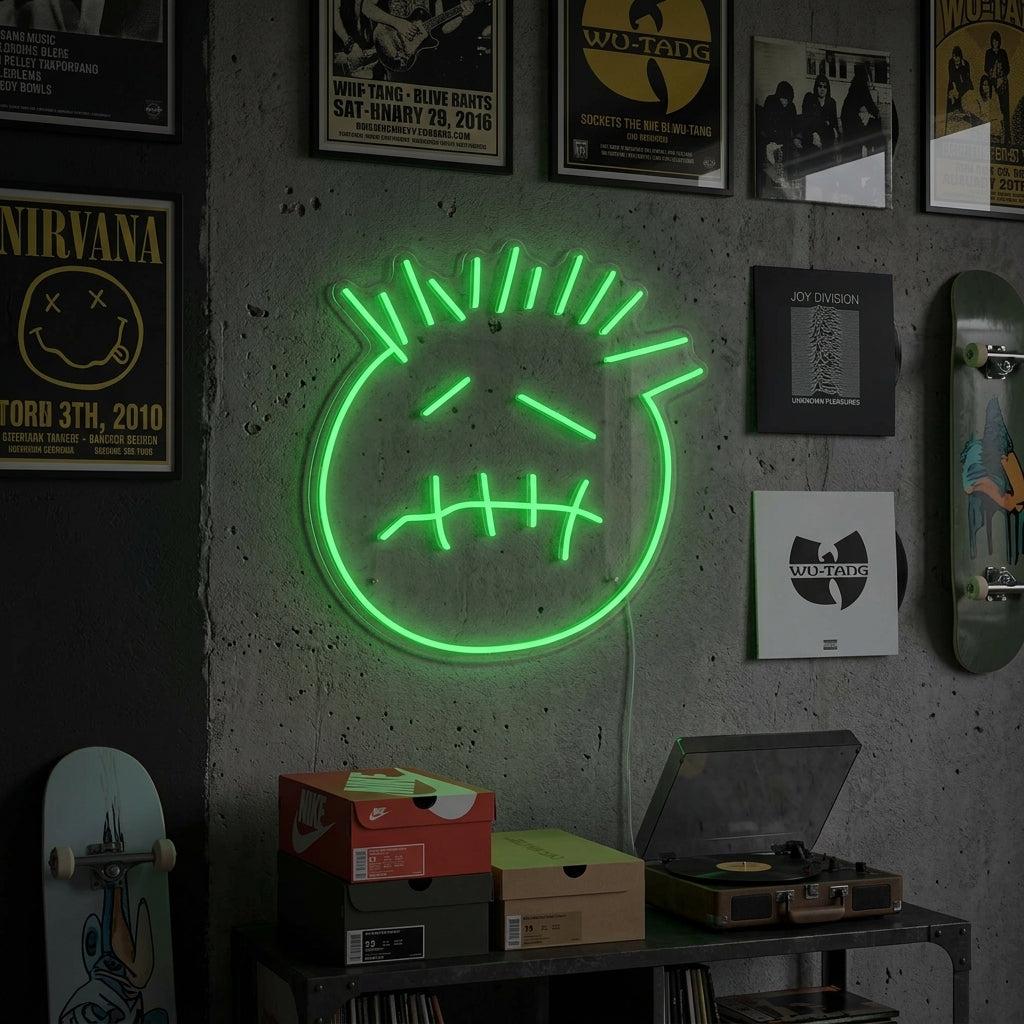 A glowing blue 'Cactus Jack Face' neon sign hangs on a brick wall above a bed and a shelf with plants, lighting up a modern room.