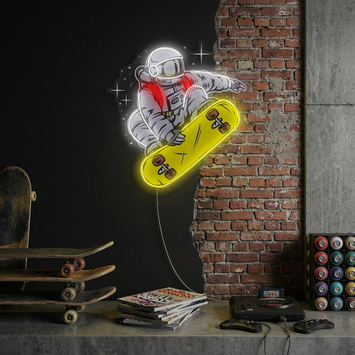 A vibrant 'Astronaut On Skateboard' neon sign featuring a blue, yellow, and white glowing design of an astronaut riding a skateboard in space, mounted on a dark brick wall above a gaming desk.