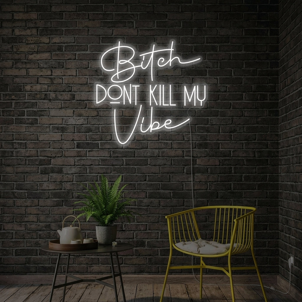 Bitch Dont Kill My Vibe neon sign glowing on a textured wall in a styled room.