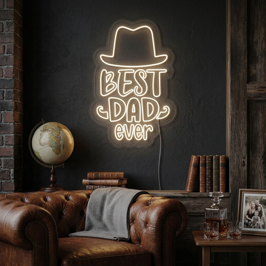 A person holding a large, illuminated orange "Best Dad Ever" neon sign in a decorated living room, with a soft background of cozy lighting.