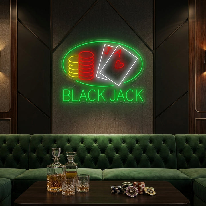 A Black Jack neon sign displaying playing cards and a chip, glowing brightly in a well-appointed room.
