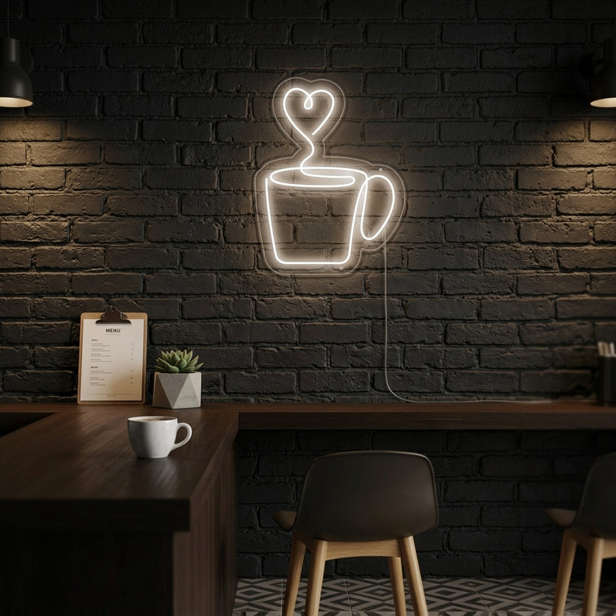 A vibrant 'Heart Coffee' neon sign glowing in bright pink above a modern wooden counter in a busy cafe setting, with blurred customers and coffee equipment in the background.