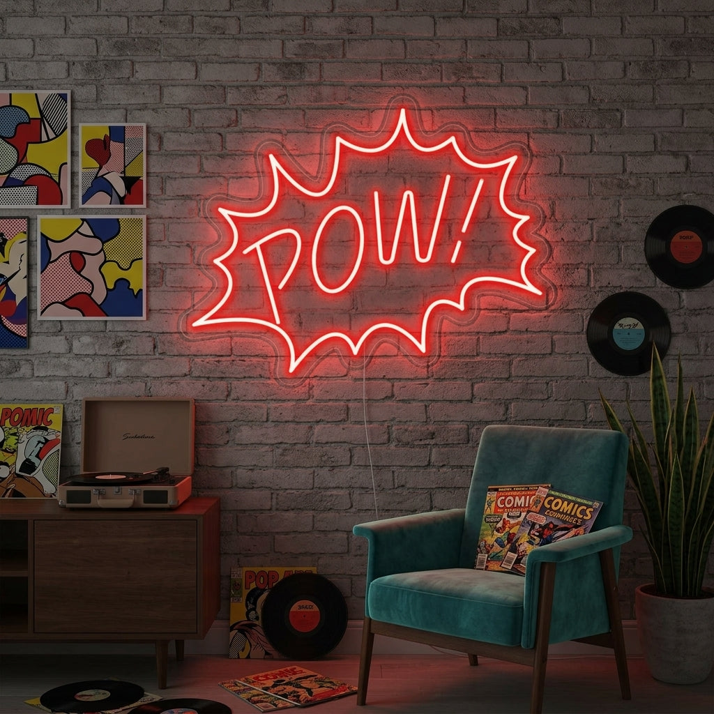 A 'Pow' neon sign in red and yellow Pop Art style glowing above a grey sofa in a modern loft apartment, creating a playful focal point.