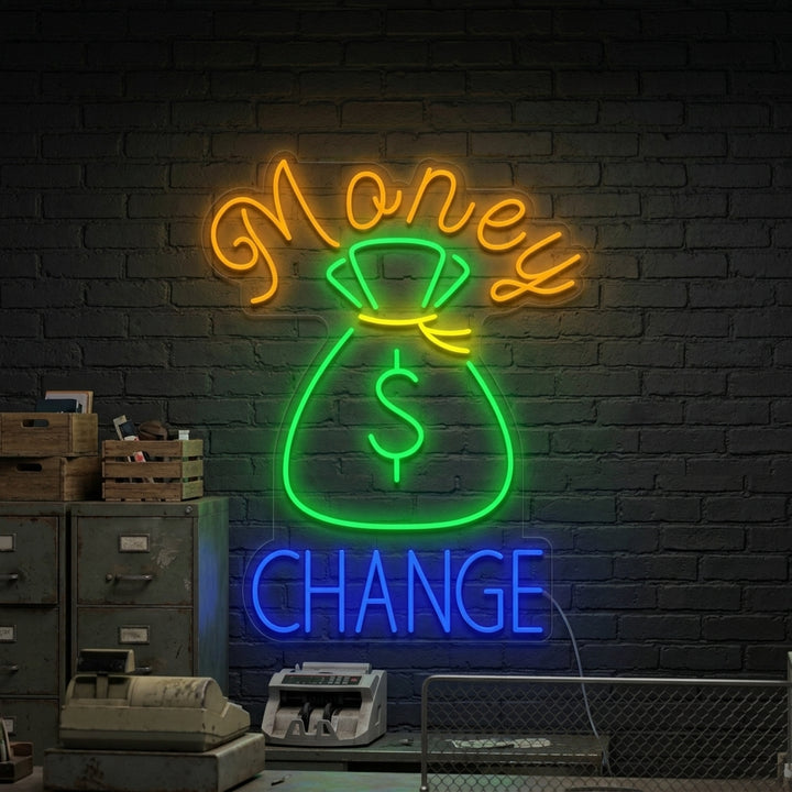 A glowing 'Money Change' neon sign featuring a dollar sign integrated with a 'C', displayed prominently in a modern office environment.