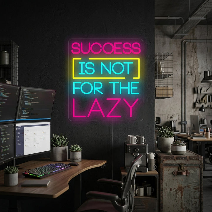 Success Is Not For The Lazy neon sign glowing warmly above a modern desk in a well-lit home office, surrounded by plants and books.