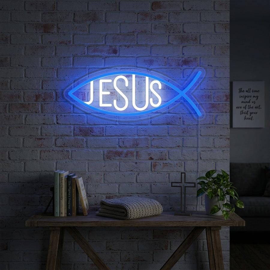 Handcrafted glowing Christian Jesus Fish neon sign mounted on a textured brick wall in a cozy living room setting.