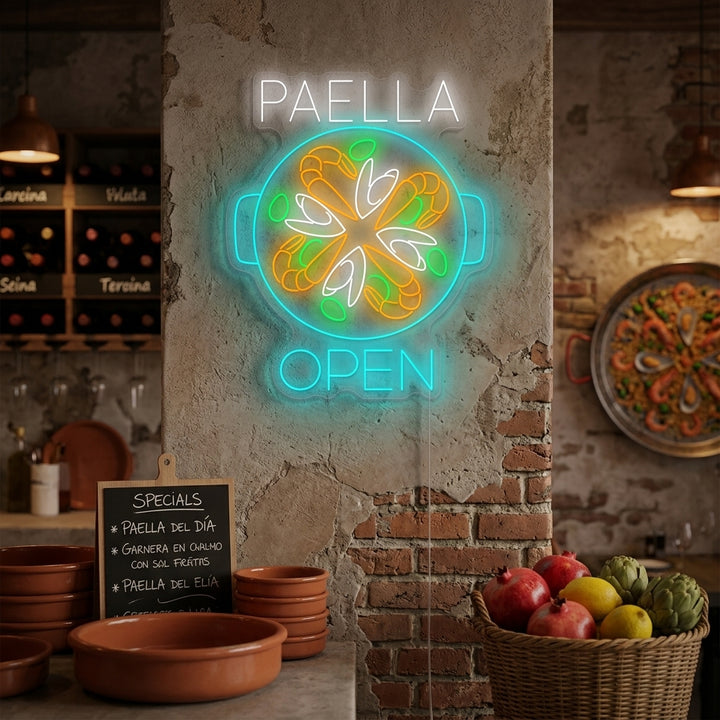 A vibrant 'Paella Open' neon sign mounted on a brick wall inside a bustling restaurant, attracting customers.
