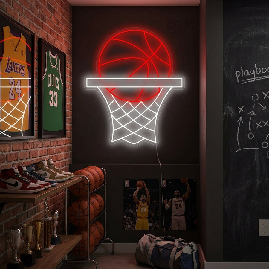 A close-up photograph of a bright, basketball hoop neon sign mounted above a dresser in a teenager's sports-themed bedroom, casting an orange glow.