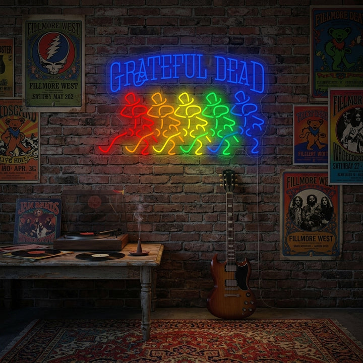 Grateful Dead neon sign glowing blue and red with iconic skull logo on a dark wall.