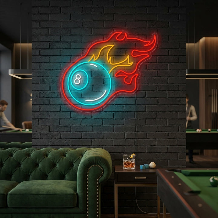 Billiards neon sign featuring a flaming 8-ball and crossed pool cues glowing above a vintage pool table in a dimly lit game room.