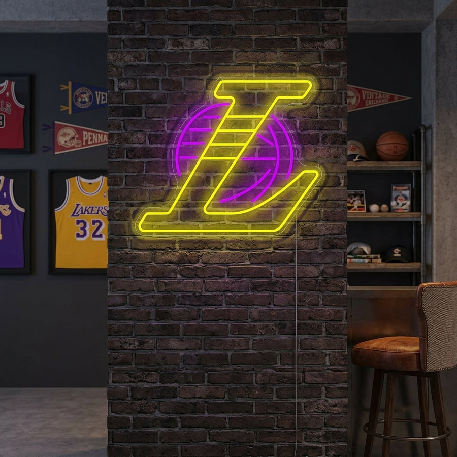A stunning LA basketball team logo neon sign illuminated above a modern media console, perfectly accessorized with basketballs and team memorabilia in a cozy game room setting.