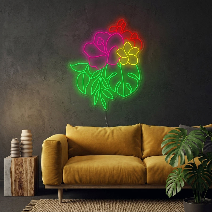Vibrant, glowing hibiscus flower neon sign mounted on a stylishly decorated living room wall above a modern sofa and plants.