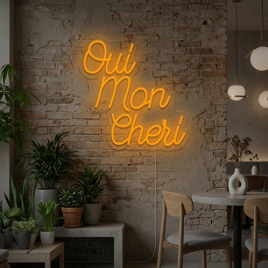 Oui Mon Cheri French Oh Sweety neon sign glowing above a bed in a stylish bedroom