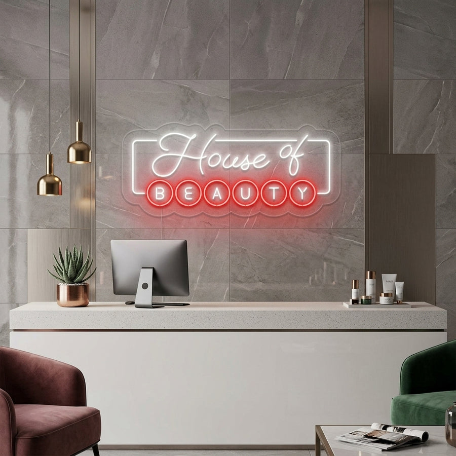 The 'House of Beauty' neon sign glowing with a warm pink light on a textured salon wall above a stylish modern armchair.
