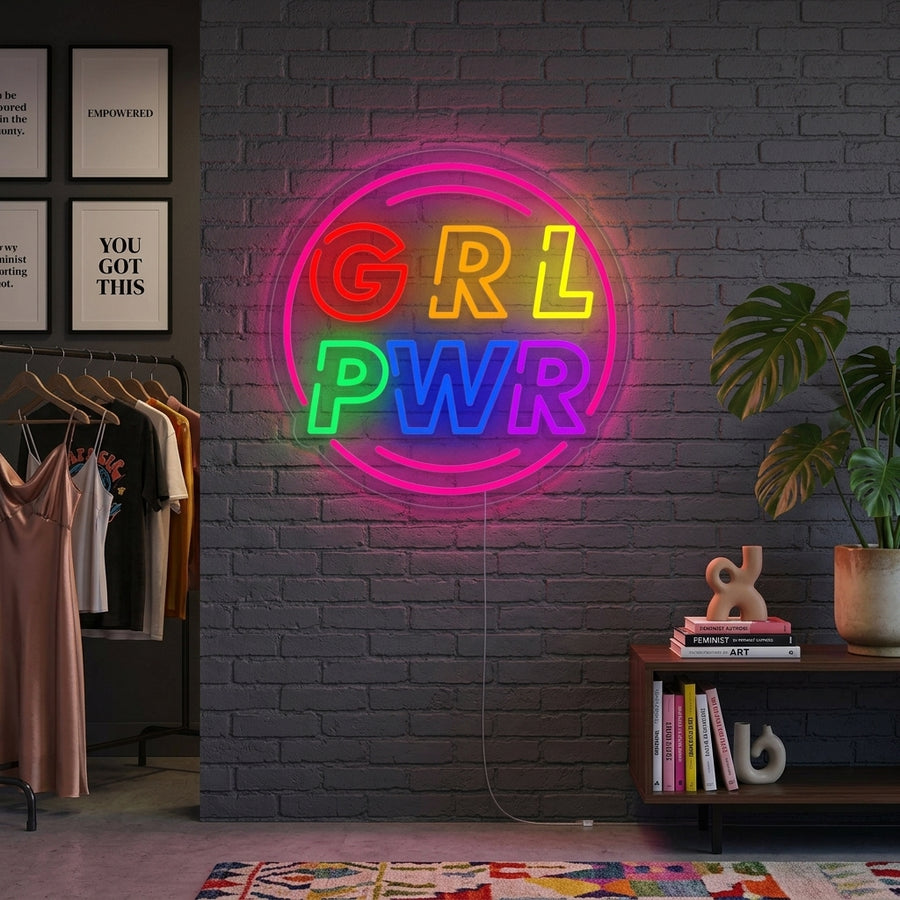 A lifestyle shot of the lit "Girl Power with Circle" neon sign on an interior wall.