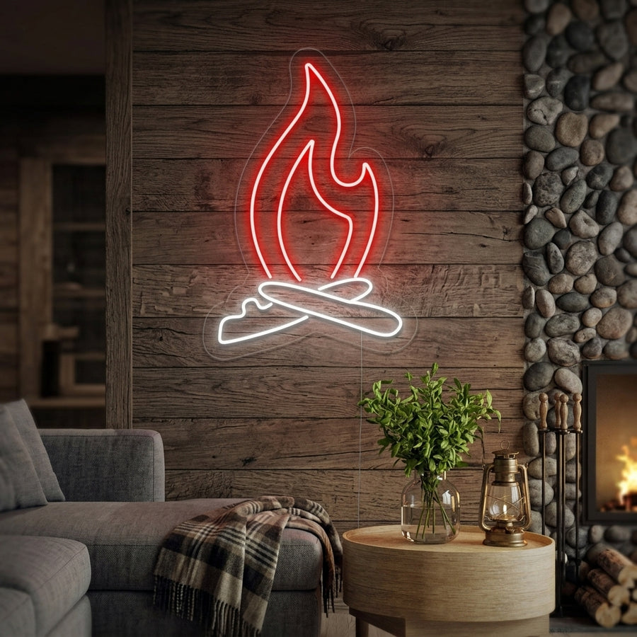 A cozy living room wall featuring a glowing orange neon sign in the shape of a campfire flame above a rustic fireplace.