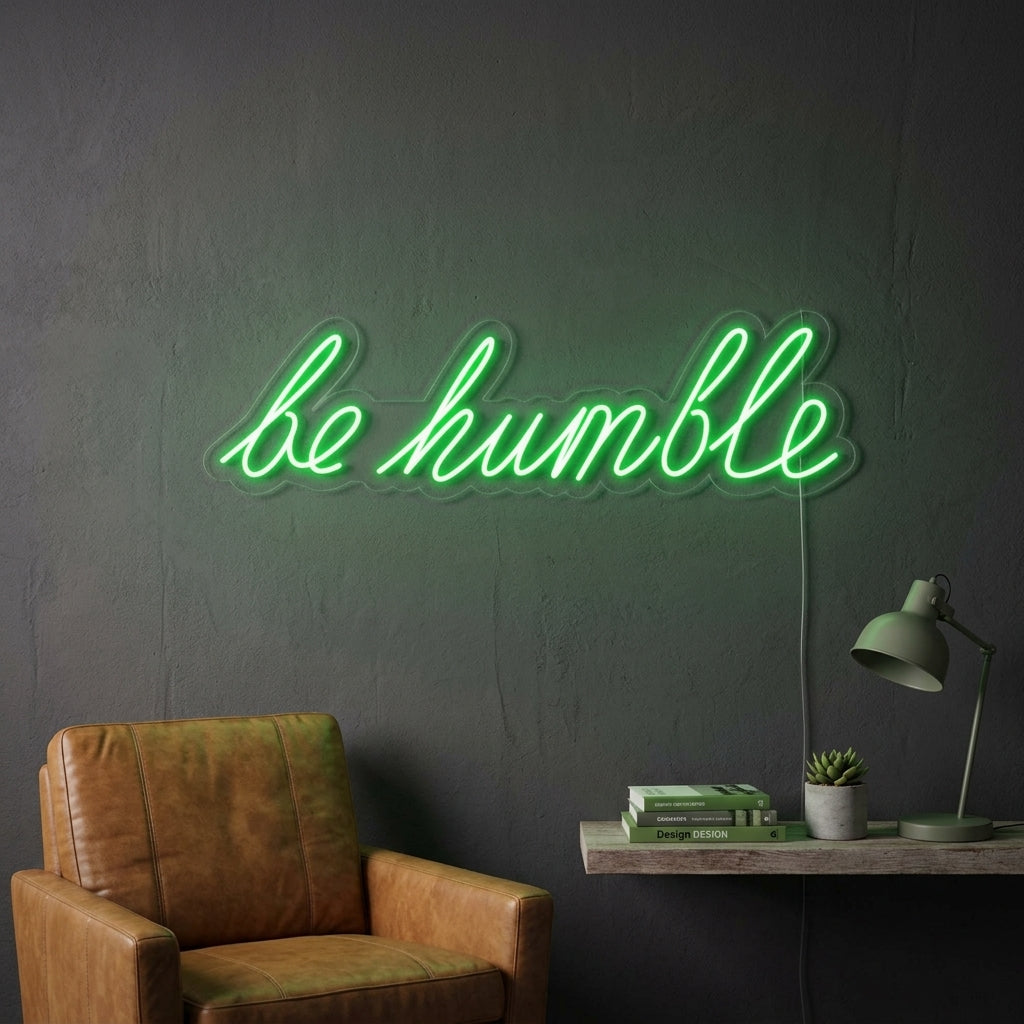 A glowing 'Be Humble' neon sign illuminates a cozy modern living room.