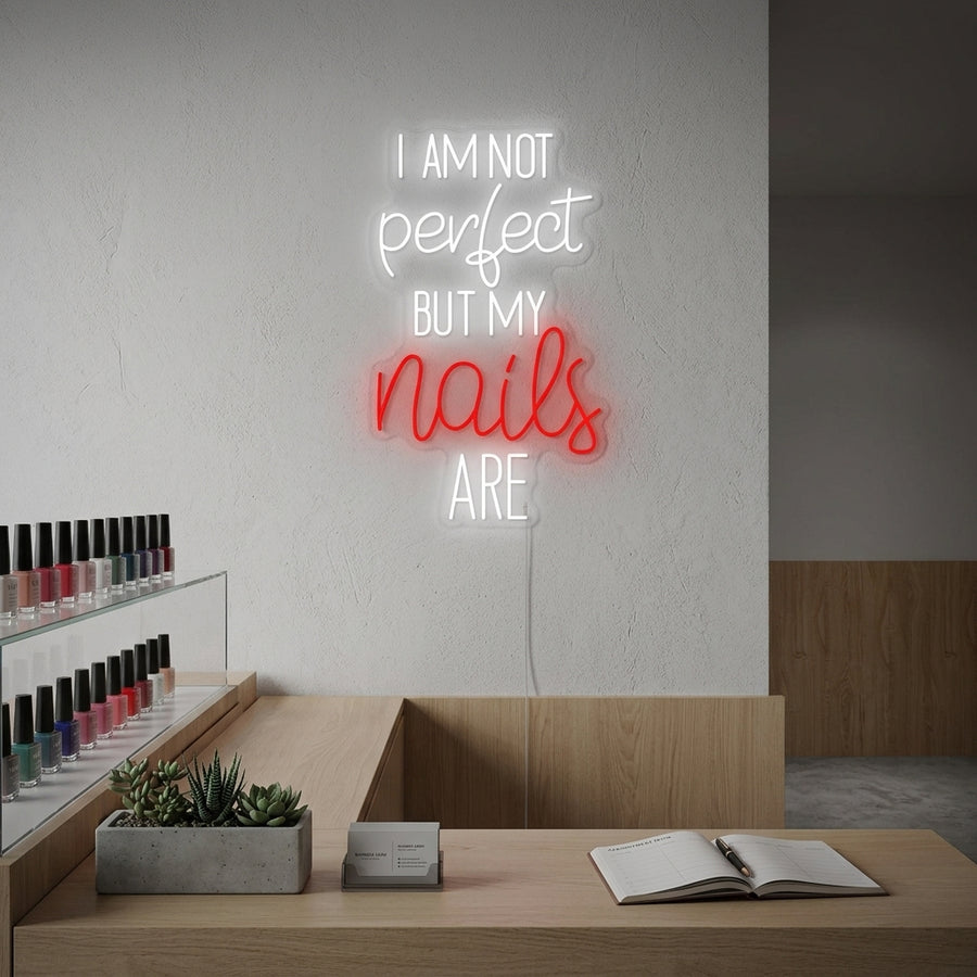 Lifestyle image of 'I Am Not Perfect But My Nails Are' neon sign illuminating a stylish nail salon interior.