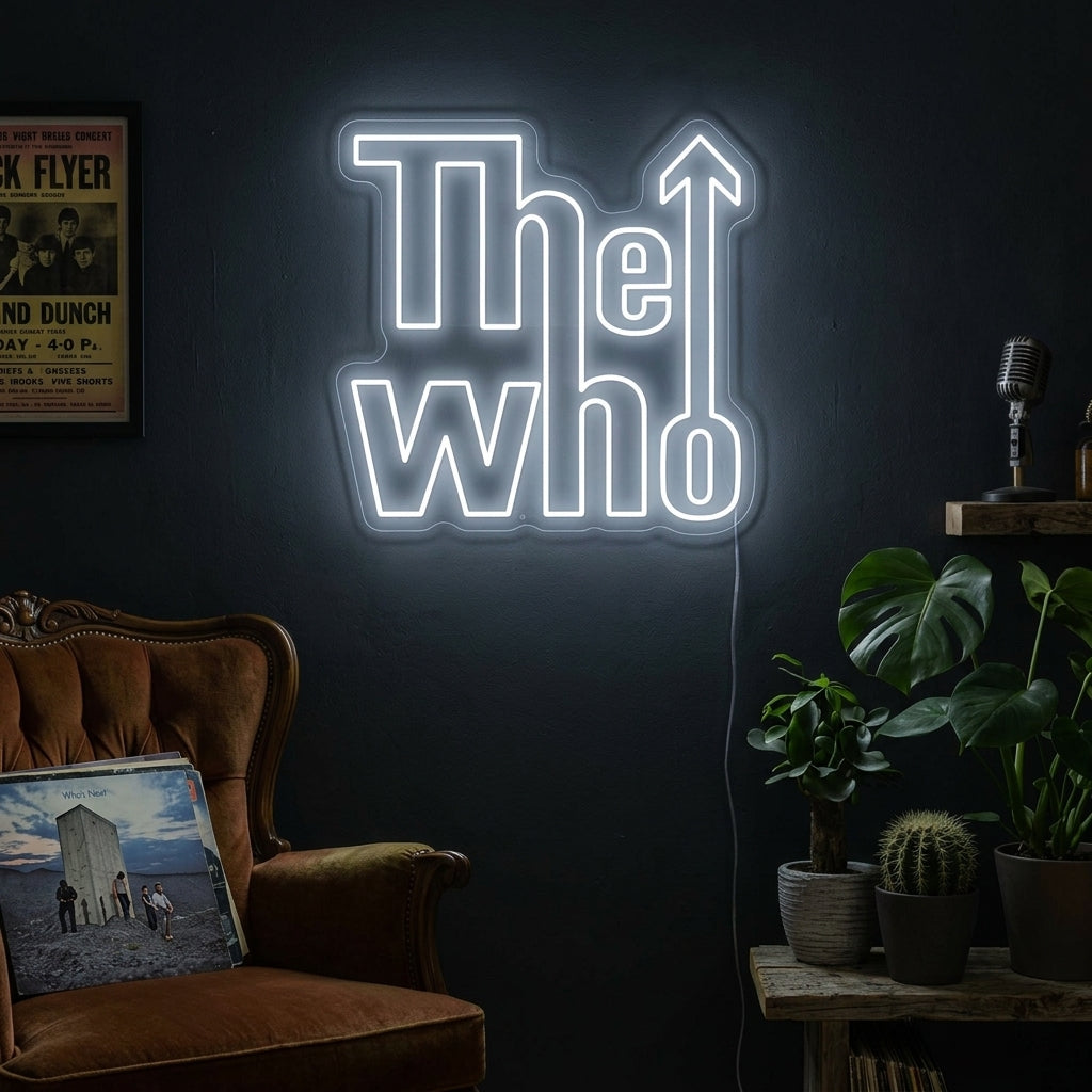 A lifestyle shot of 'The Who' neon sign lit up and hanging on a brick wall in a cozy room above vintage rock posters.