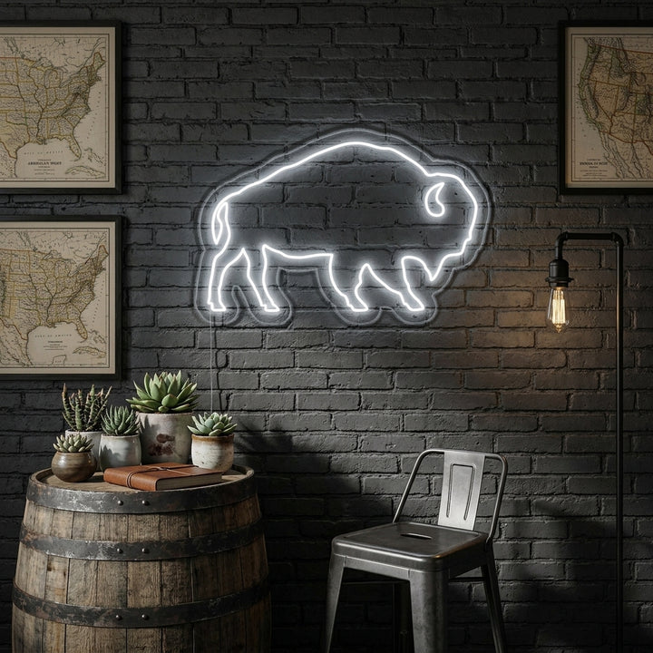 A lifestyle photograph of the illuminated Buffalo neon sign mounted on a rustic wall above a dark console table with decor, showing its size and the atmospheric glow.