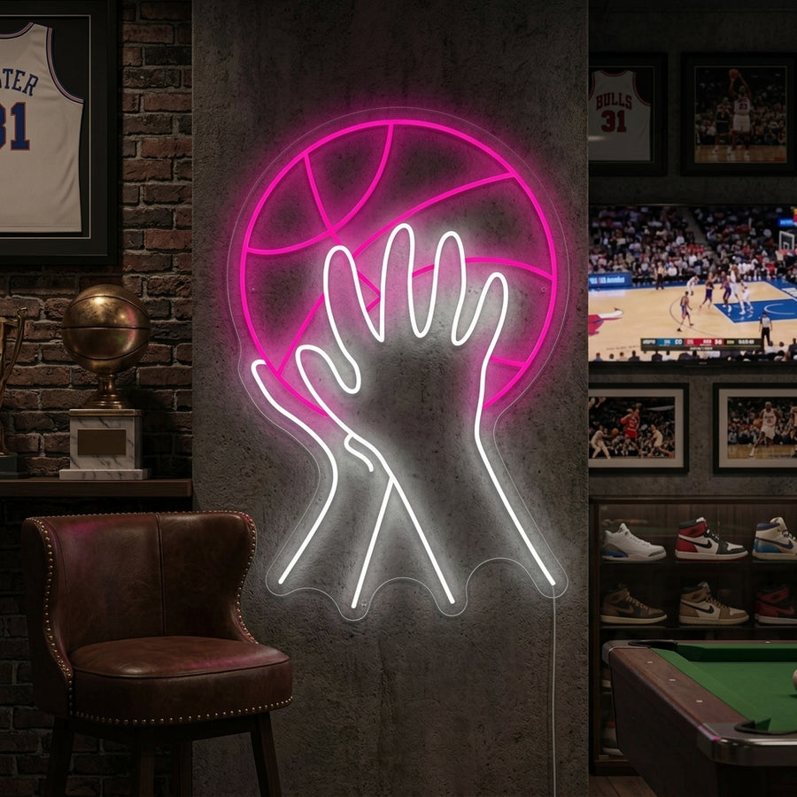 A 'Shooting Basketball' neon sign featuring a dynamic design of a player in action, mounted on a textured brick wall in a rustic-themed game room above a leather sofa.