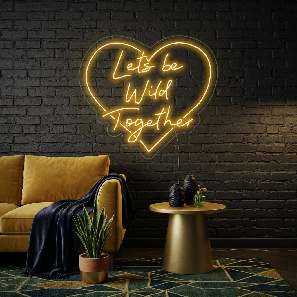 A candid style photo shows the 'Lets Be Wild Together' neon sign glowing above a decorated head table at a wedding reception.
