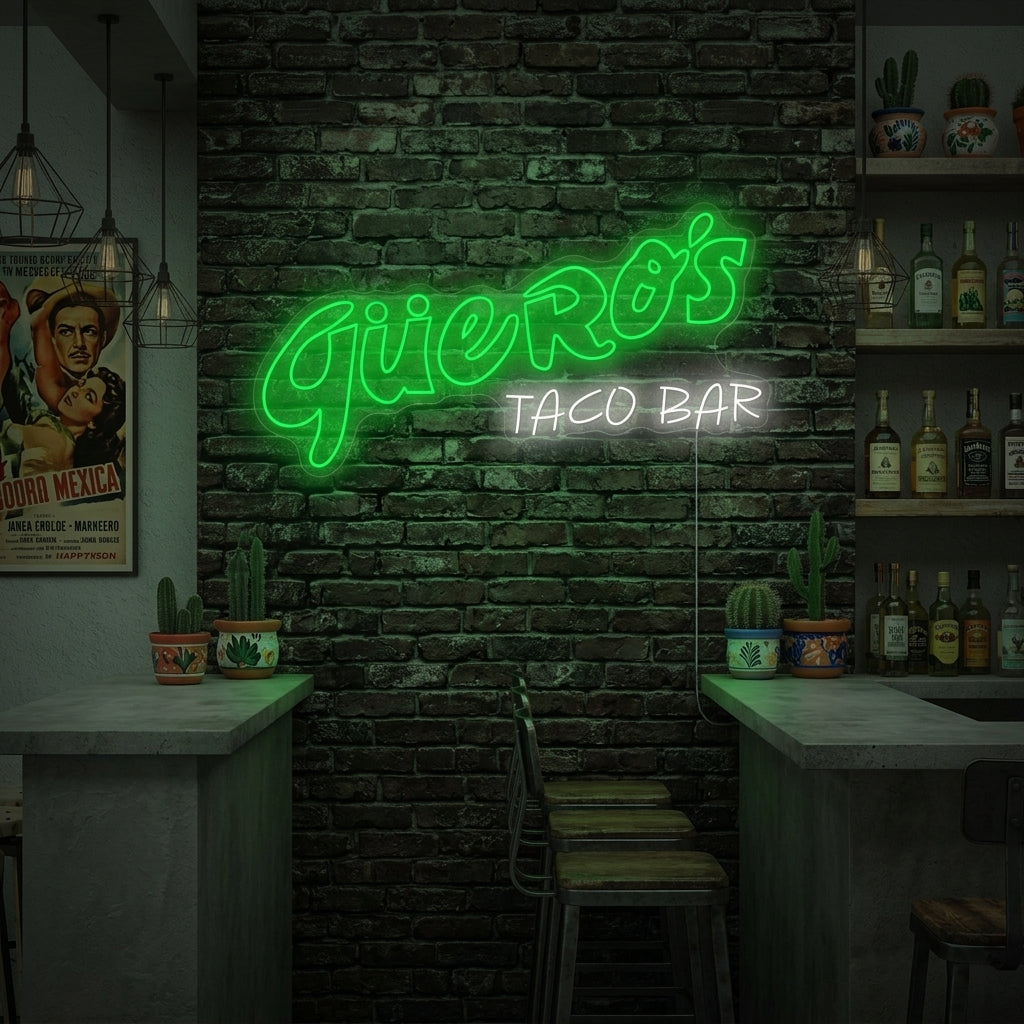 Guero's Taco Bar neon sign displayed on a brick wall, glowing blue and yellow, above a wooden table with Mexican food and drinks.