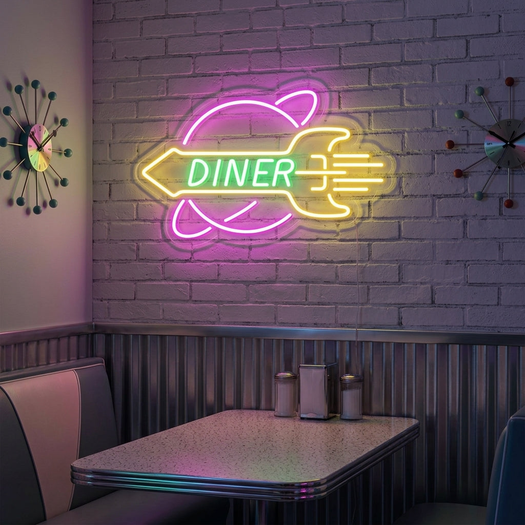 A vibrant ROCKET Rocket Diner neon sign showing a blue and red rocket over bold yellow and red script text, casting a colorful glow against a patterned diner wall above a booth.