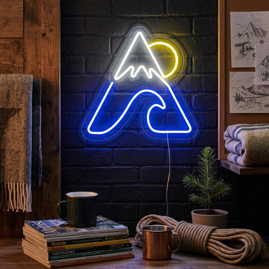A glowing 'Mountain Sea Sun' neon sign featuring a sun, mountains, and waves mounted in a modern living room