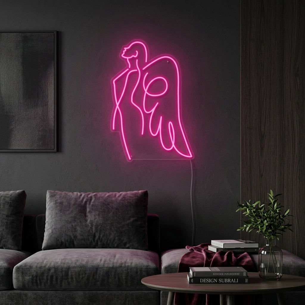 Handcrafted Angel Mom neon sign illuminated in a warm glow on a soft pink wall in a home setting.
