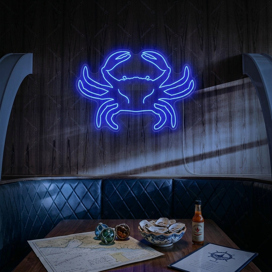 A close-up photograph showing the vibrant red Crab neon sign glowing brightly on a textured grey brick wall above a kitchen counter with fresh produce.