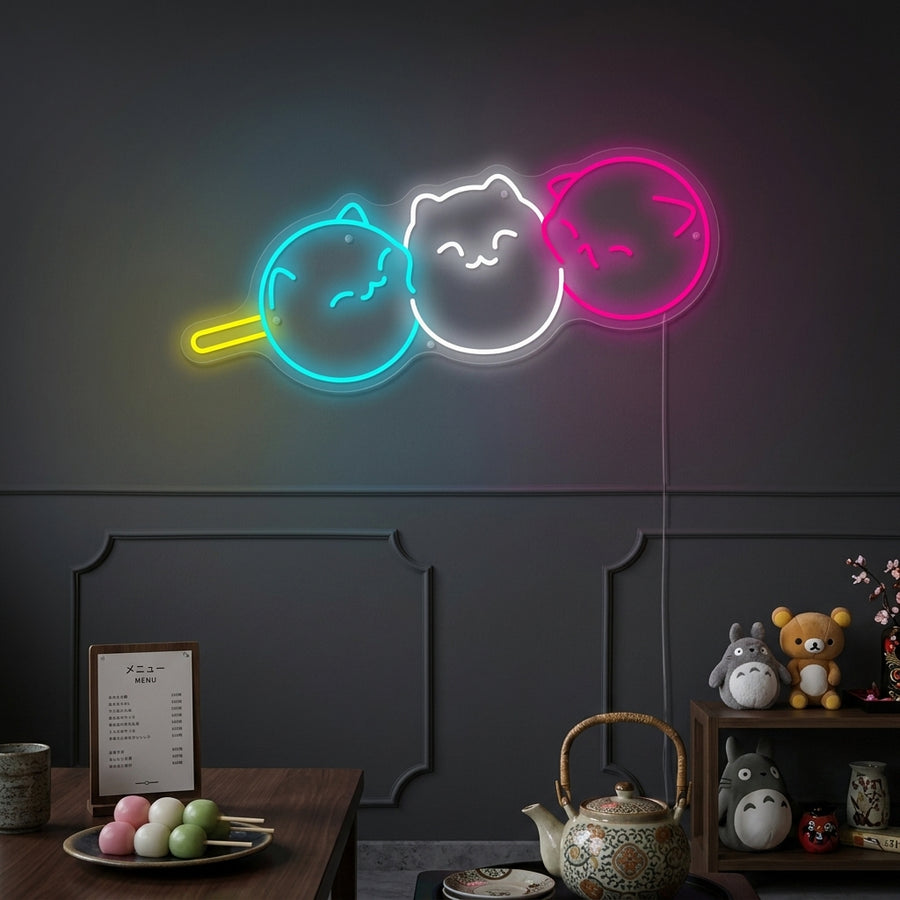 A cozy living room featuring the illuminated Kawaii Japanese Dango Cat neon sign hanging above a stylish chair, creating a cute aesthetic.