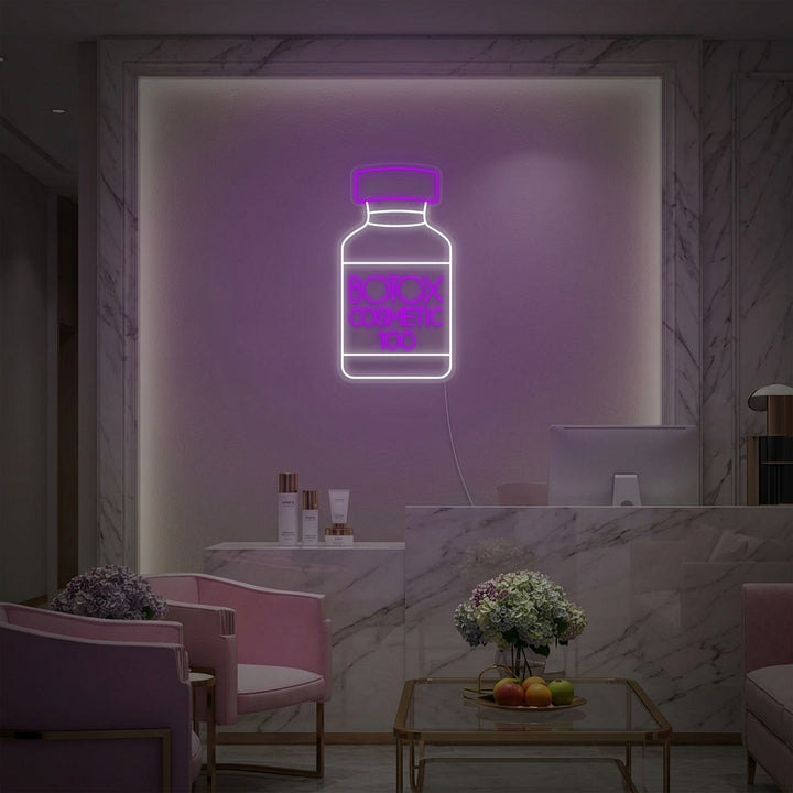 Professional 'Botox Cosmetic Shop Skin Care Center' neon sign displayed on a treatment room wall above skincare products, creating an inviting medical spa atmosphere.