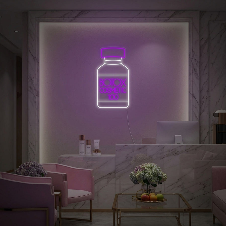 Professional 'Botox Cosmetic Shop Skin Care Center' neon sign displayed on a treatment room wall above skincare products, creating an inviting medical spa atmosphere.