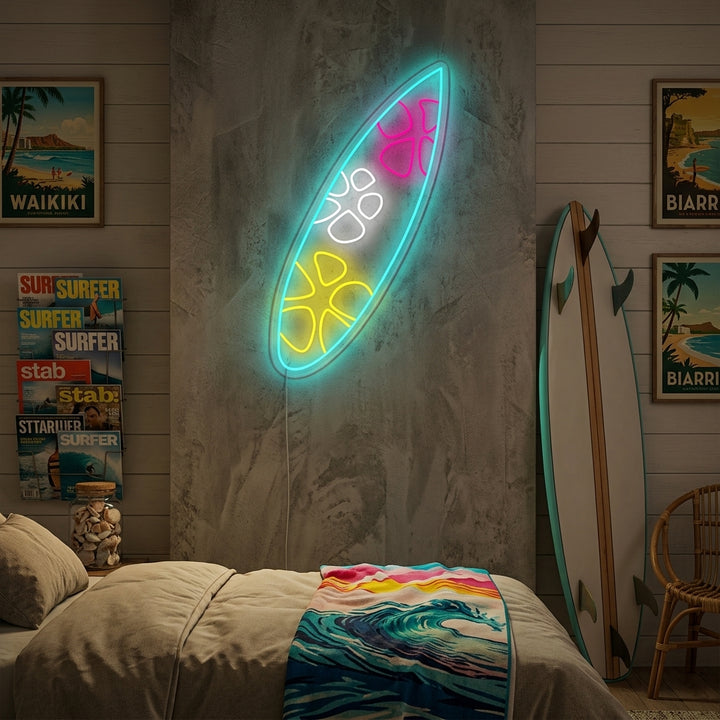 A glowing blue surfboard-shaped neon sign mounted on a beachy wood paneled wall above a shelf with coastal decor.