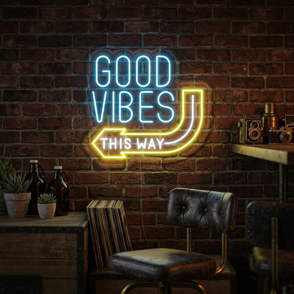 A glowing 'Good Vibes This Way' neon sign hanging above a modern sofa in a well-lit living room.