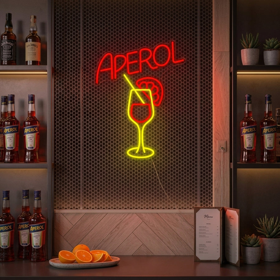 Aperol Bar neon sign glowing brightly on an exposed brick wall, creating a warm ambiance in a stylish home bar setting with bottles and cocktail tools in the foreground.