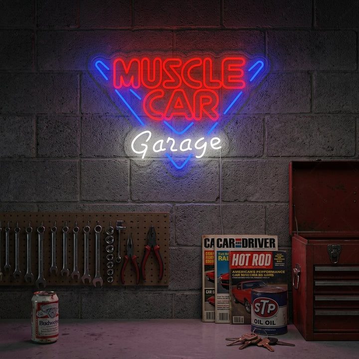 A vibrant 'Muscle Car Garage' neon sign glowing red and blue above a classic car in a well-equipped garage setting.