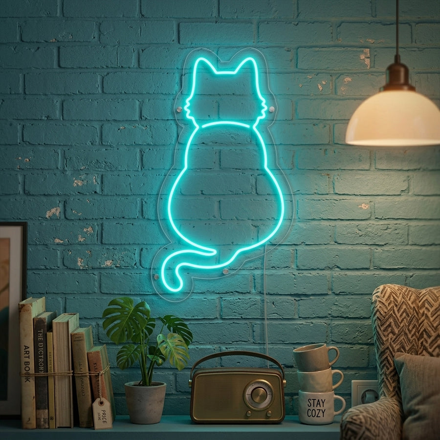 An illuminated neon wall sign depicting a stylized cat outline, emitting a warm glow as it hangs in a modern bedroom interior setting.