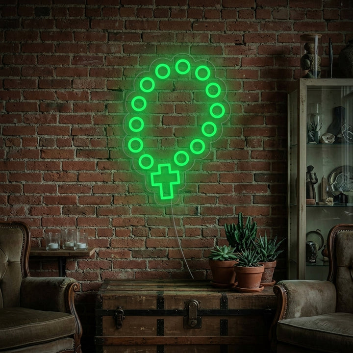 A lifestyle photo showing the illuminated 'Rosary Beads' neon sign glowing softly on a wall in a contemporary living space.