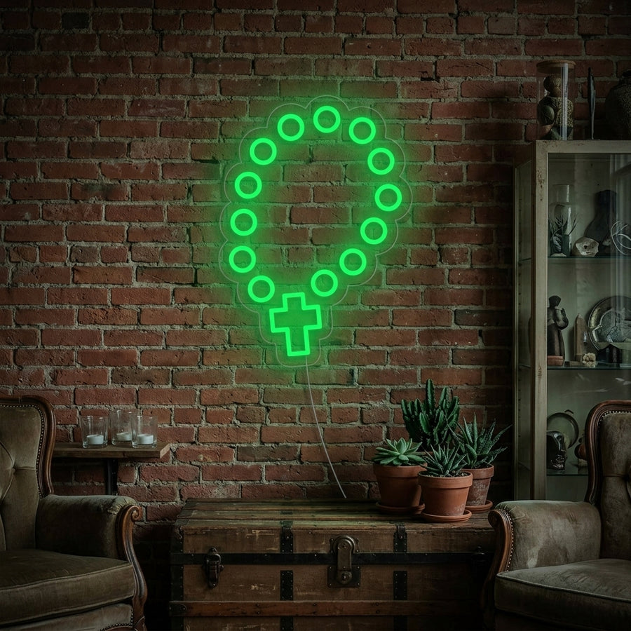 A lifestyle photo showing the illuminated 'Rosary Beads' neon sign glowing softly on a wall in a contemporary living space.