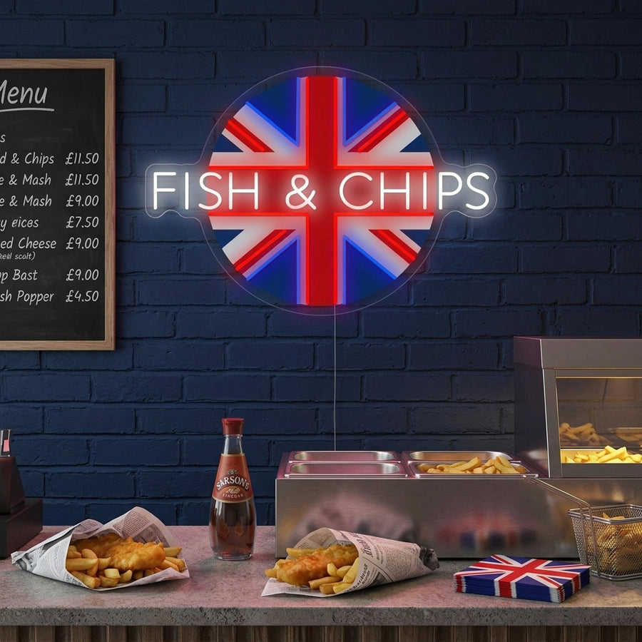 A glowing UK Fish & Chips neon sign showing a fish, chips, and 'Great British Tradition' text mounted on a rustic wood panel wall in a cozy shop setting.