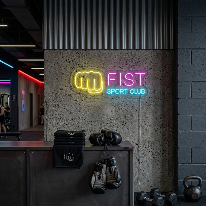 A vibrant 'Fighting Fist Sport Club' neon sign with a glowing red fist, displayed on a gym wall.