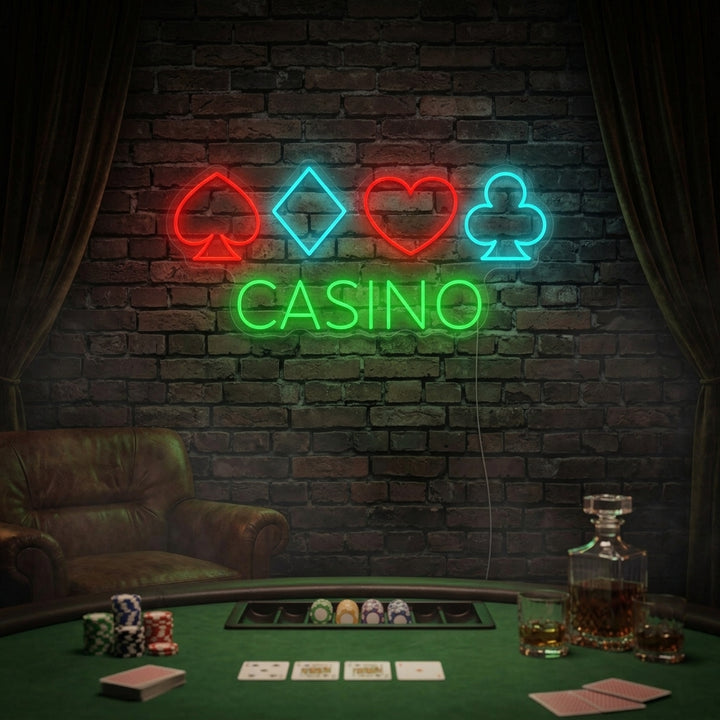 A glowing 'Casino Poker' neon sign showing cards and chips on a wall above a poker table.