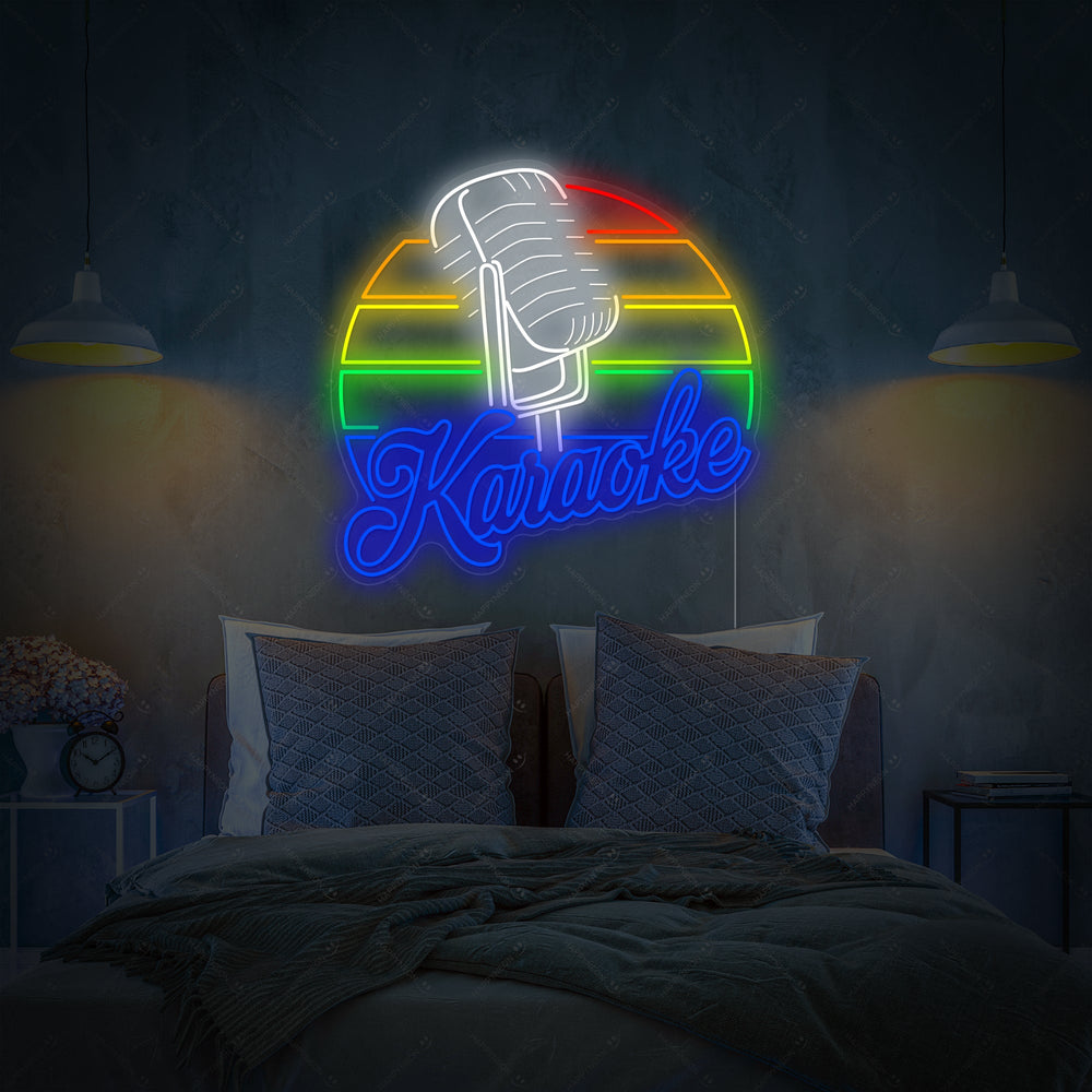 A colorful 'Karaoke' neon sign glowing above a bed in a modern bedroom, featuring a microphone icon and bold lettering against dark teal wall paneling.