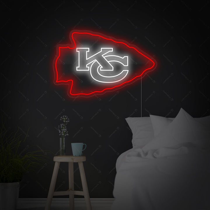 A flat design mockup showcasing the KC Chiefs neon sign glowing against a dark, minimalist bedroom backdrop.