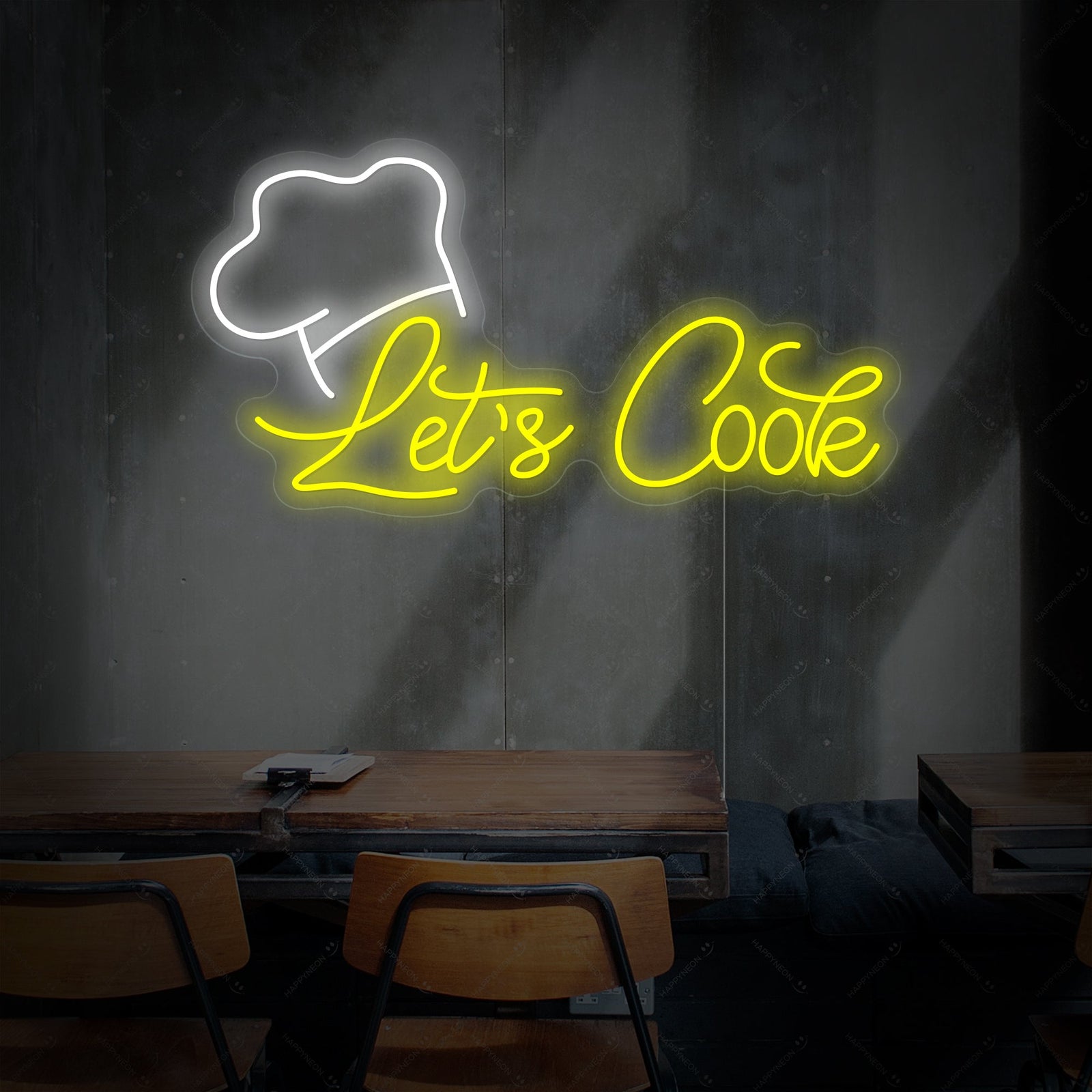 Close up of 'Let's Cook' text neon sign showing vibrant light tubes against a black brick wall background