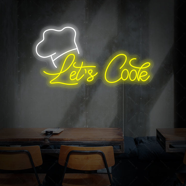 Close up of 'Let's Cook' text neon sign showing vibrant light tubes against a black brick wall background